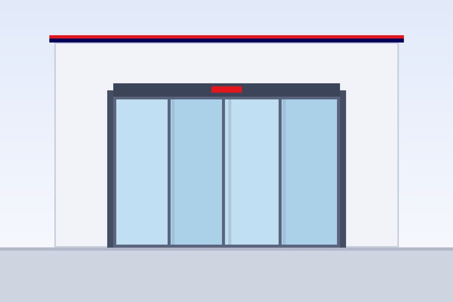 Automatic glass sliding entrance of a commercial building with a revolving door beside it