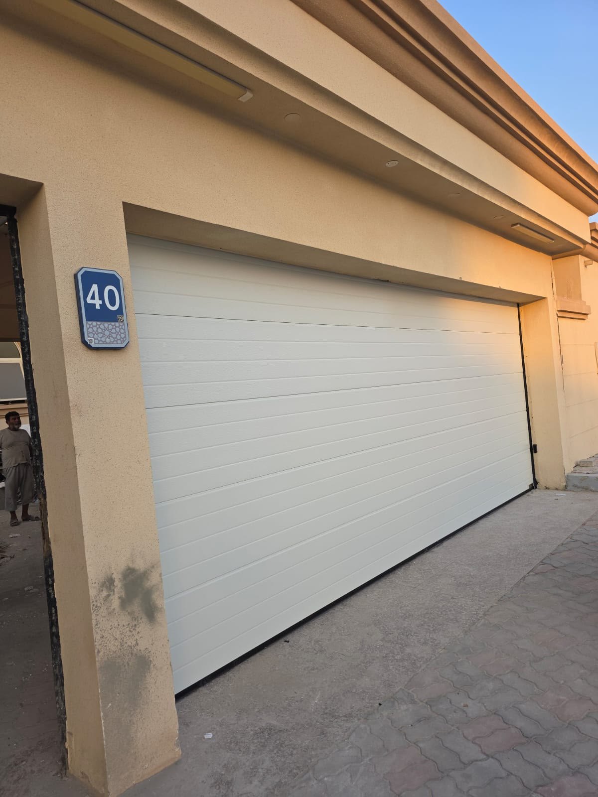 Cream sectional garage door installed on a villa in Al Bateen, Abu Dhabi