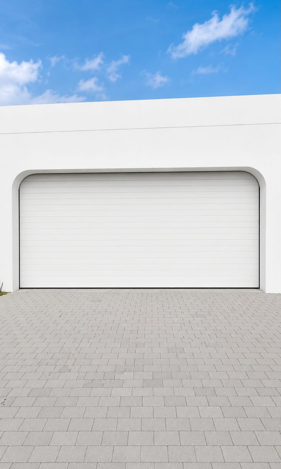 White sectional garage door installed in an arched opening on a villa in Jumeirah, Dubai