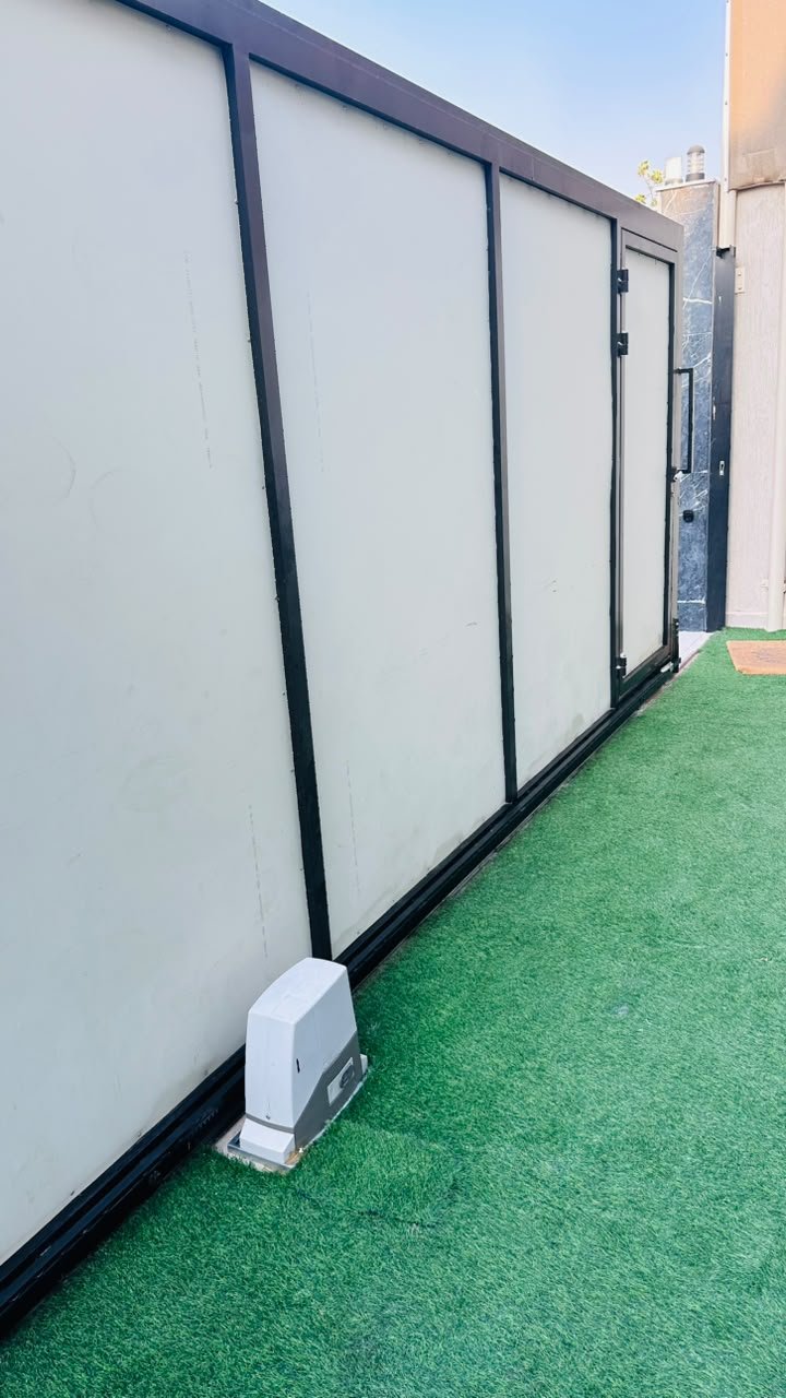 Close view of the sliding gate motor and base plate on a panel gate, Al Yasmeen, Ajman