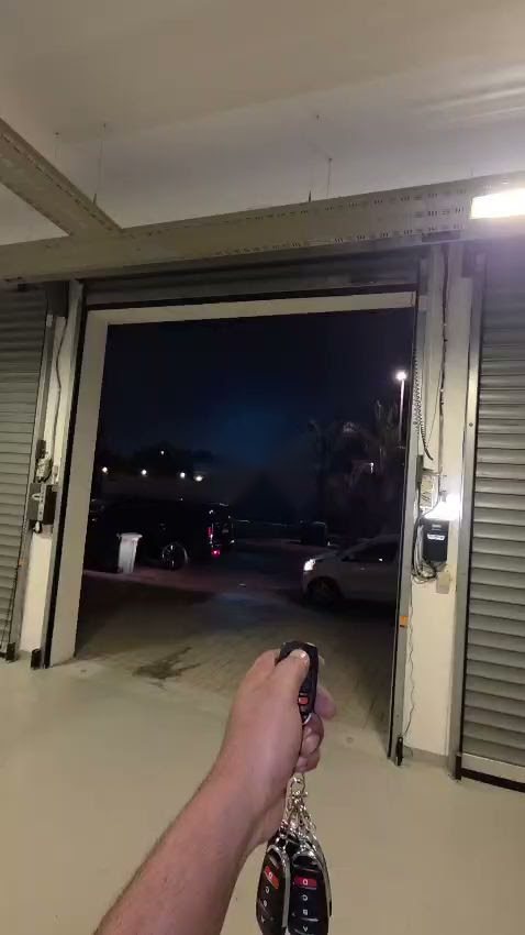 Sommer tubular motor opening an existing Hormann rolling shutter with a remote control in Al Barsha, Dubai